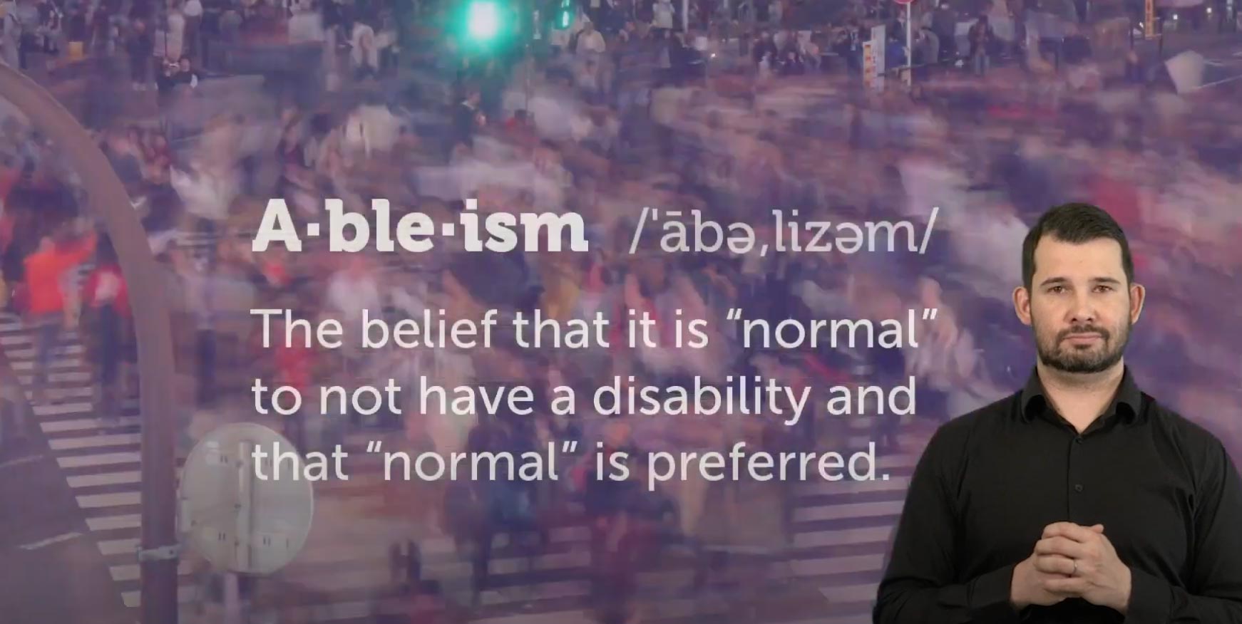 A video snapshot with the word ableism and meaning. A ASL interpreter waits to begin signing.