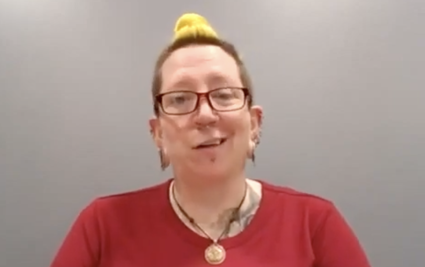 Ursula Mogensen talks to a camera. They have short