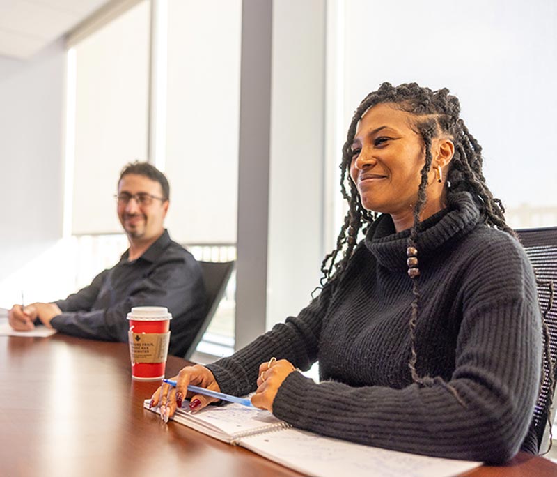 Black Female and White Male sitting at the conference table